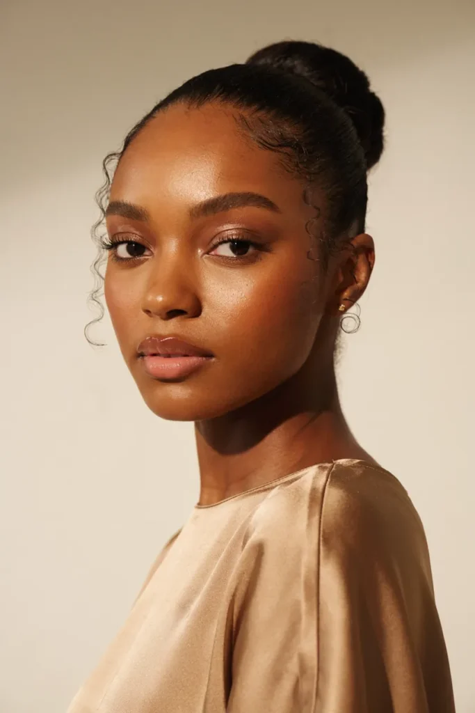 Classic High Bun with Face-Framing Curls